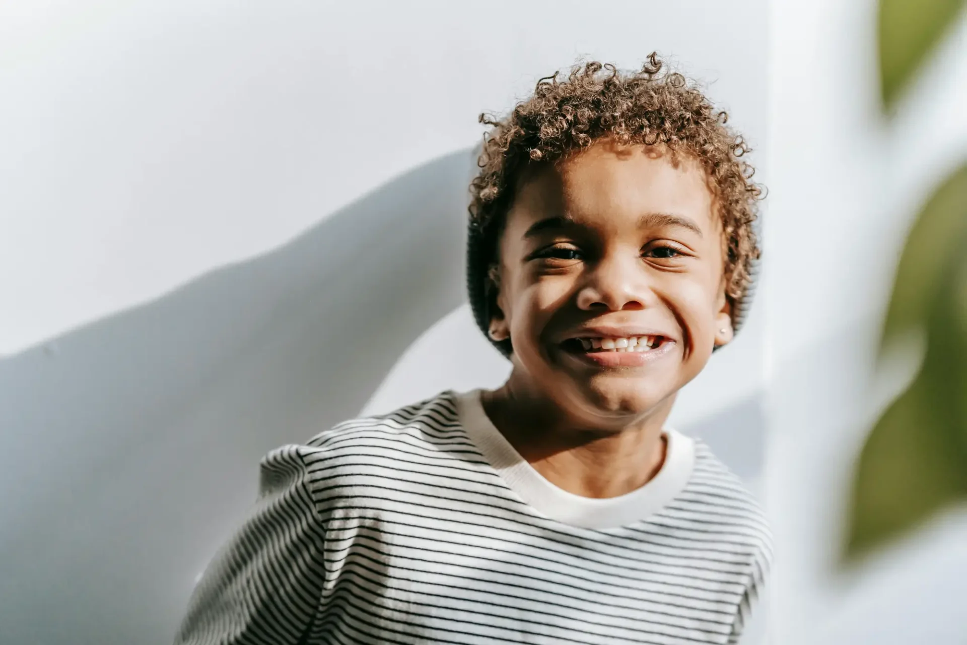 A young boy smiling for the camera.