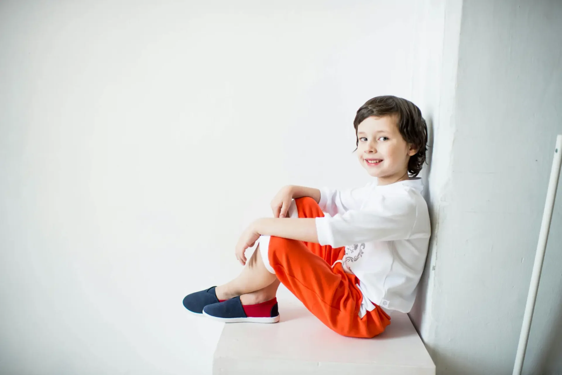 A young boy sitting on top of a chair.