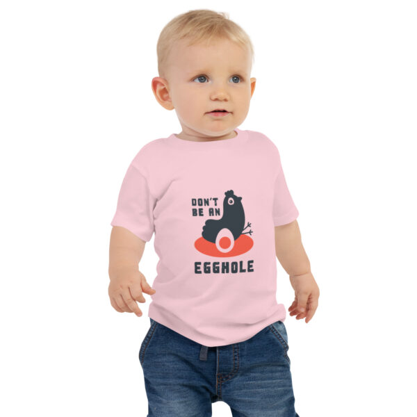 A toddler wearing a t-shirt with an image of a cat.