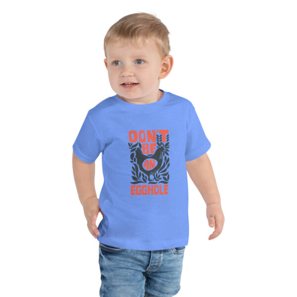 A toddler wearing jeans and a t-shirt