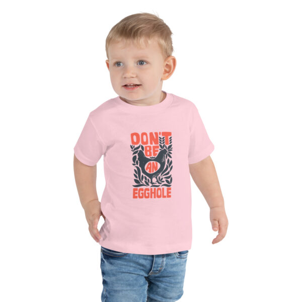 A toddler wearing jeans and a t-shirt.