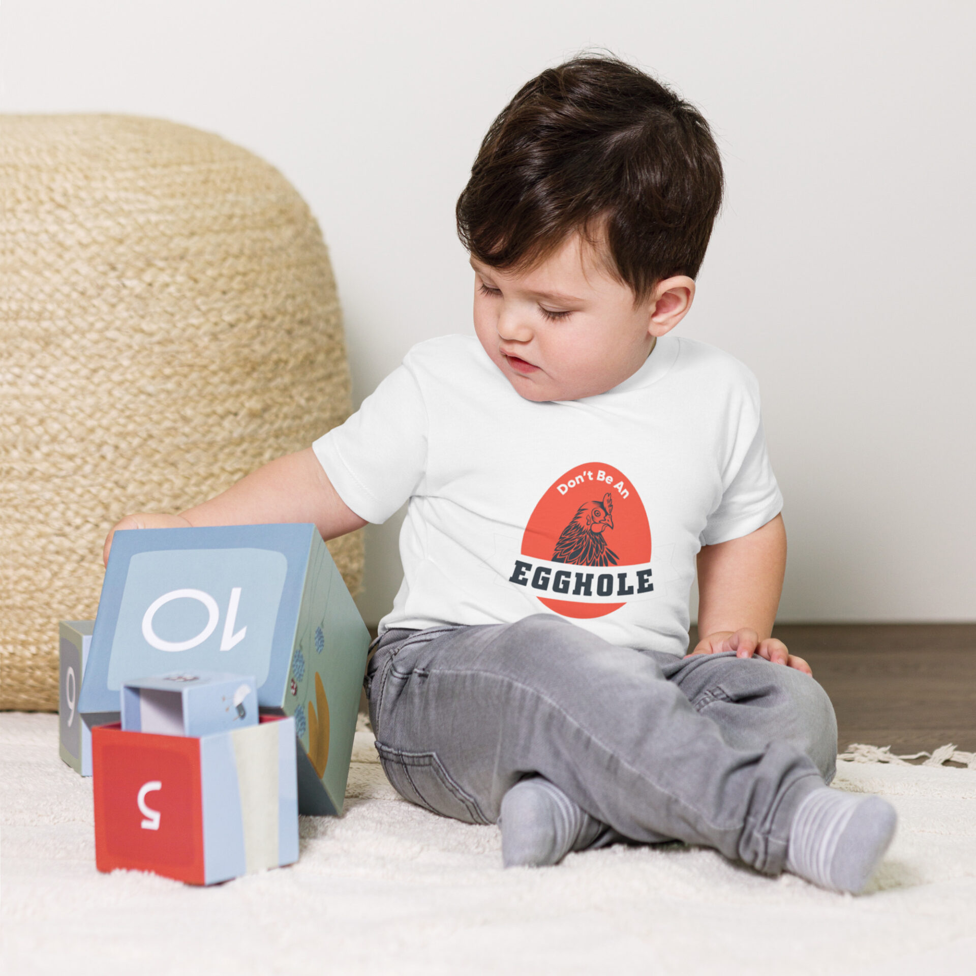 A toddler playing with a toy on the floor