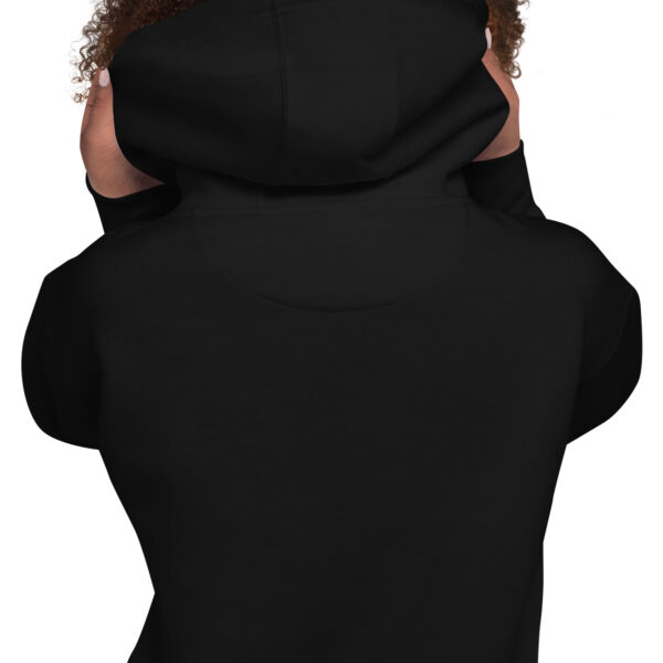 A person wearing a black hoodie with fur on the hood.