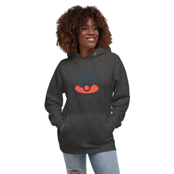 A woman is wearing a hoodie with an image of a face.