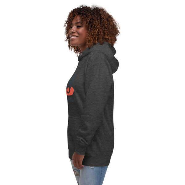 A woman wearing a black hoodie with an orange logo.