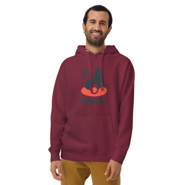 A man wearing a maroon hoodie with an image of a cat.