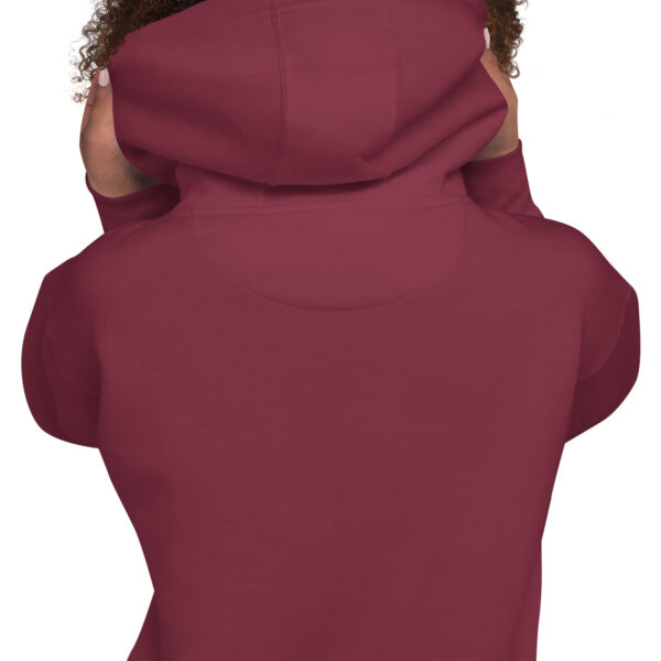 A person wearing a maroon hoodie with a cat on the back.