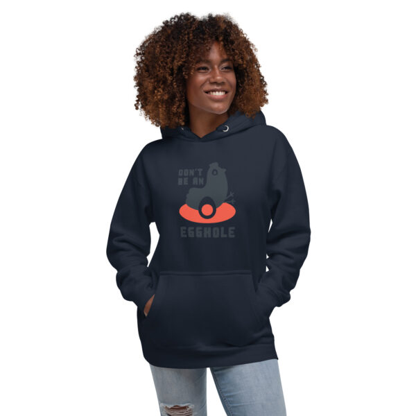 A woman wearing a black hoodie with an orange face.