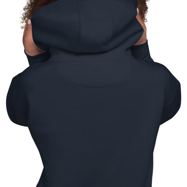 A person wearing a black hoodie with their hands on the back of it.