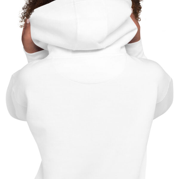 A person wearing a white hoodie with a cat on it.