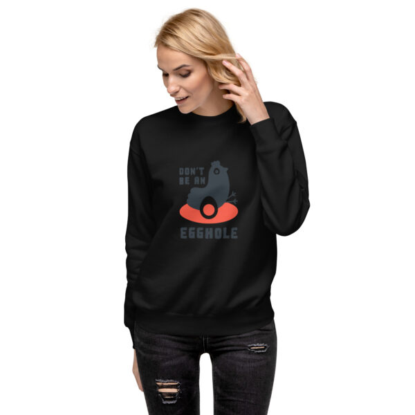 A woman wearing black sweatshirt with an image of a cat.