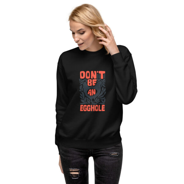 A woman wearing a black sweatshirt with the words don 't be on eggroll