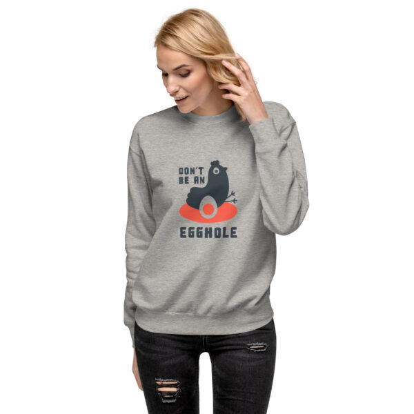 A woman wearing a sweatshirt with an image of a cat.