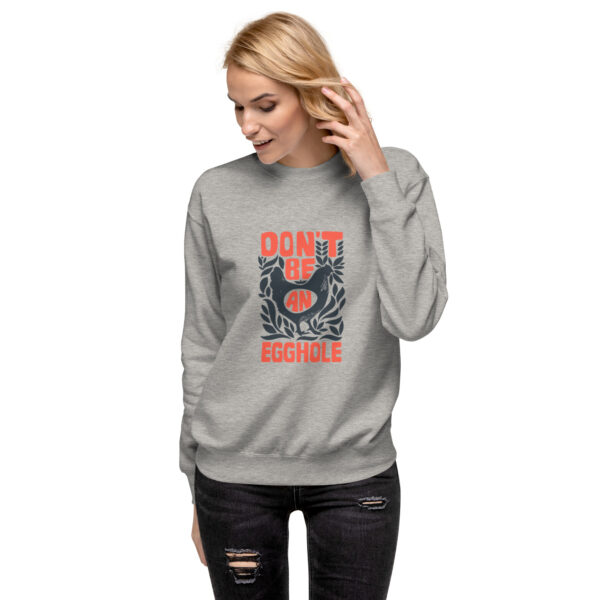 A woman wearing a sweatshirt with an image of a bird.