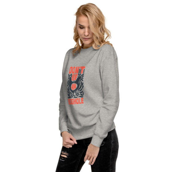 A woman wearing a sweatshirt with an image of a flower.