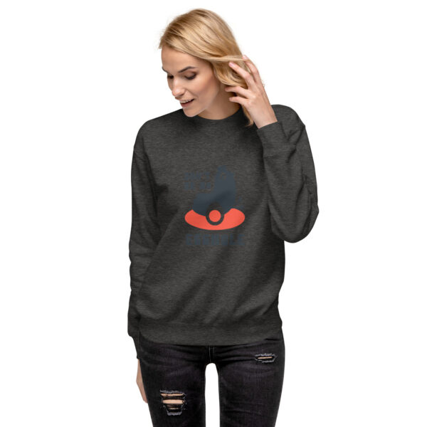 A woman wearing a sweatshirt with an image of a face.