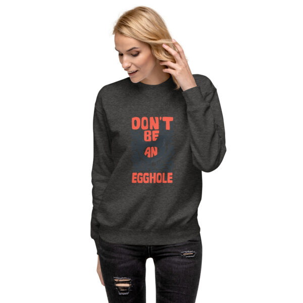 A woman wearing a black sweatshirt with an orange lettering.