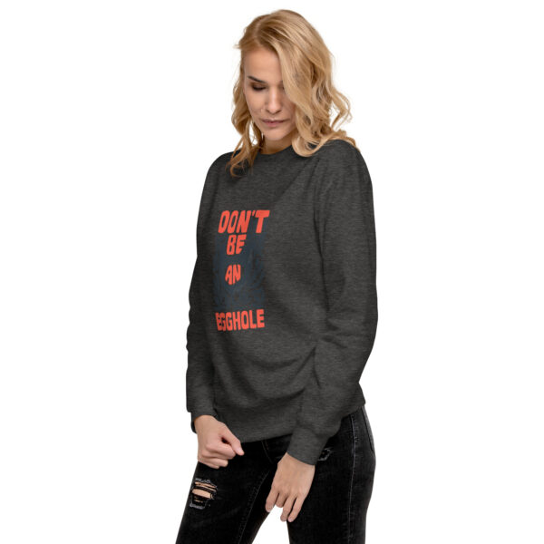 A woman wearing an athletic sweatshirt with the words " don 't be terrible ".