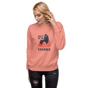 A woman wearing an orange sweatshirt with the words don 't be an ex-mex on it.