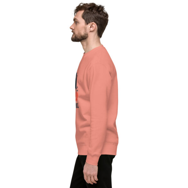 A man in a pink sweatshirt is standing up