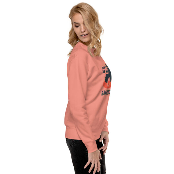 A woman wearing an orange sweatshirt with the words " no image ".