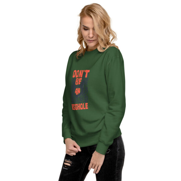 A woman in green sweatshirt with text " don 't be terrible ".