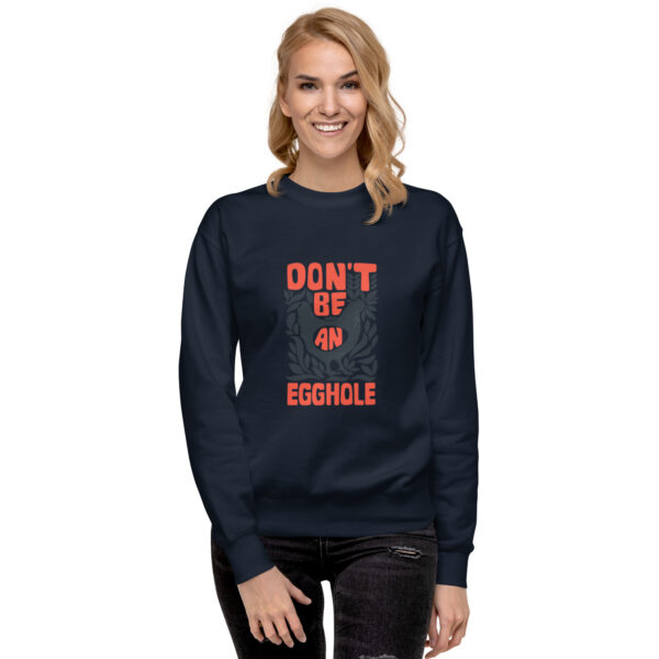 A woman wearing a sweatshirt that says don 't sit at the table.