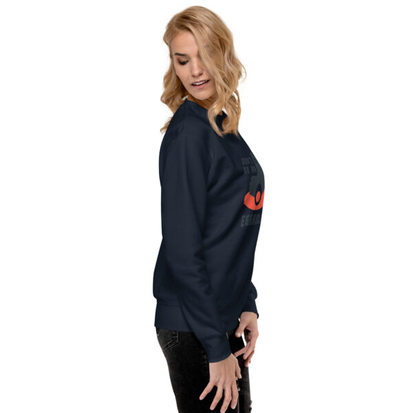 A woman wearing a black sweatshirt with red heart on it.