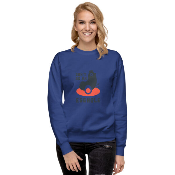 A woman wearing a sweatshirt with an image of a cat on it.