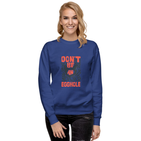 A woman wearing a blue sweatshirt with the words don 't be f * ckle