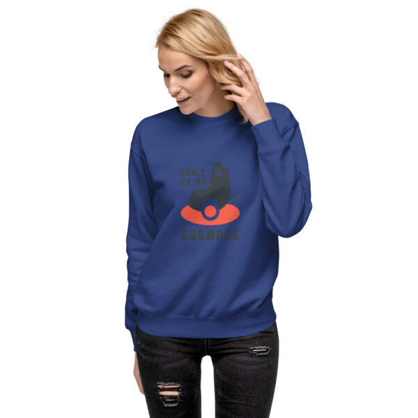 A woman wearing a sweatshirt with an image of a person on it.