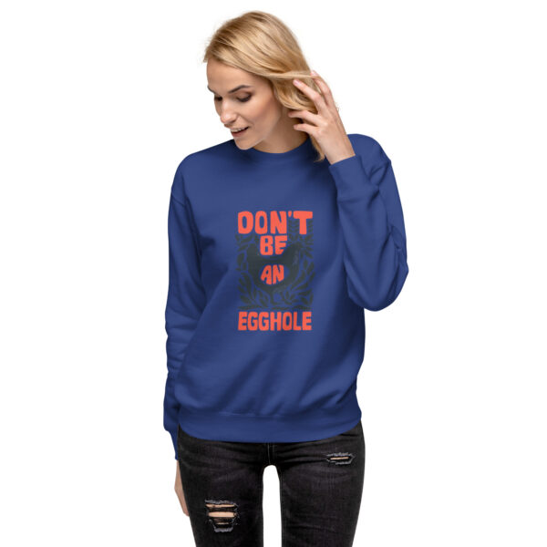 A woman wearing a blue sweatshirt with the words don 't be invisible on it.