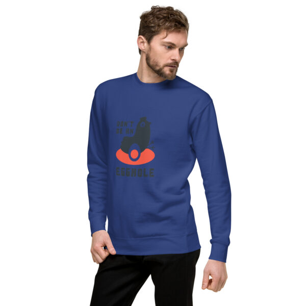 A man in blue long sleeve shirt with red heart on chest.