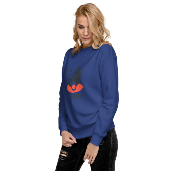 A woman wearing a blue sweatshirt with an evil looking face.