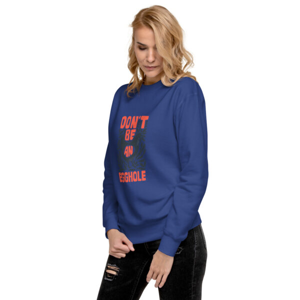 A woman wearing a blue sweatshirt with the words aunt is rebels on it.