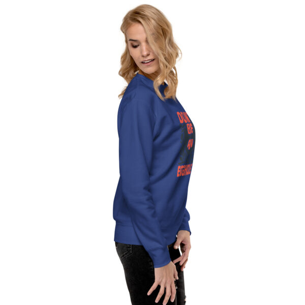 A woman wearing a blue sweatshirt with red lettering.