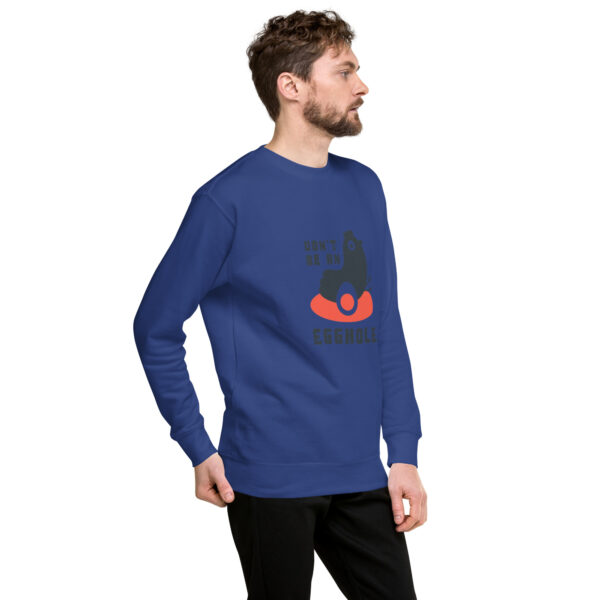 A man wearing a sweatshirt with an image of a witch 's hat.