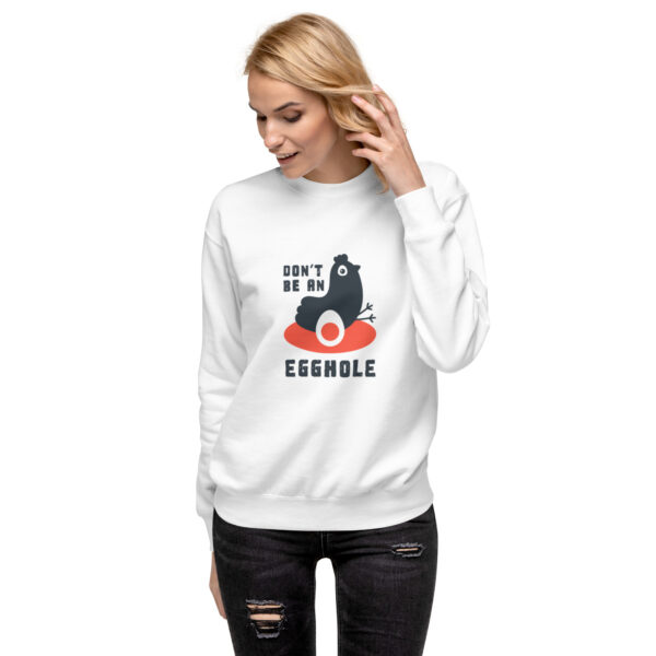 A woman wearing a white sweatshirt with an image of a cat.