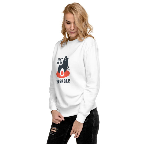 A woman wearing a white sweatshirt with an image of a cat.