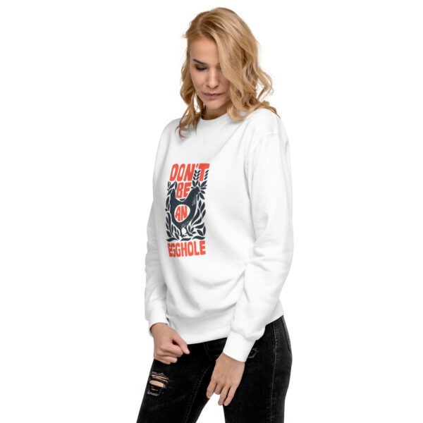 A woman wearing white sweatshirt with an image of a person on it.