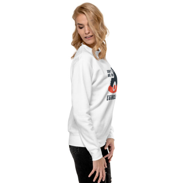 A woman wearing a white sweatshirt with an image of a person.