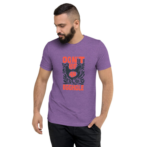 A man wearing a purple t-shirt with the words don 't touch my phone.