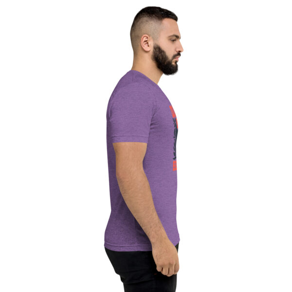 A man with a beard is wearing a purple shirt