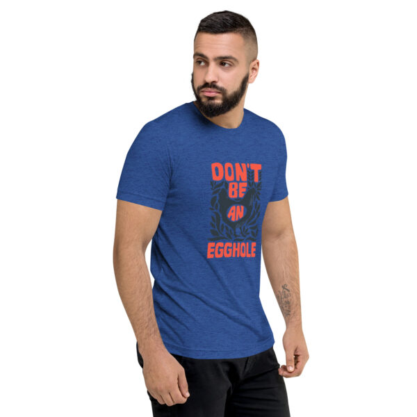 A man wearing a blue t-shirt with the words don 't be jungle