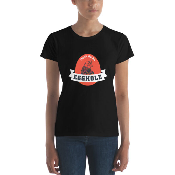 A woman is wearing a black t-shirt with the word trouble on it.