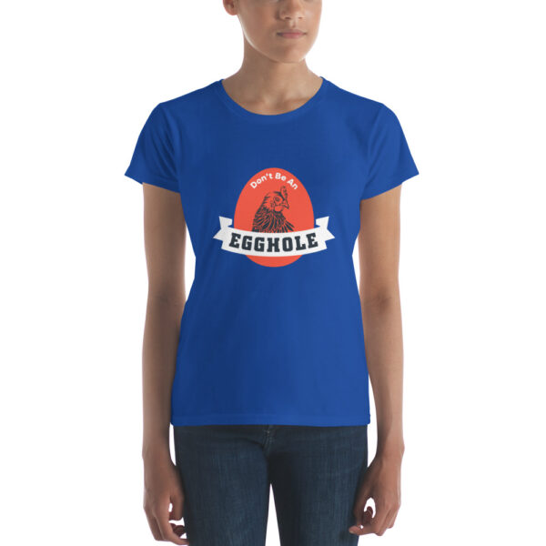 A woman wearing a blue t-shirt with the word " rockets " on it.