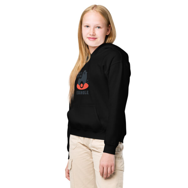 A girl wearing black hoodie with red and white logo.