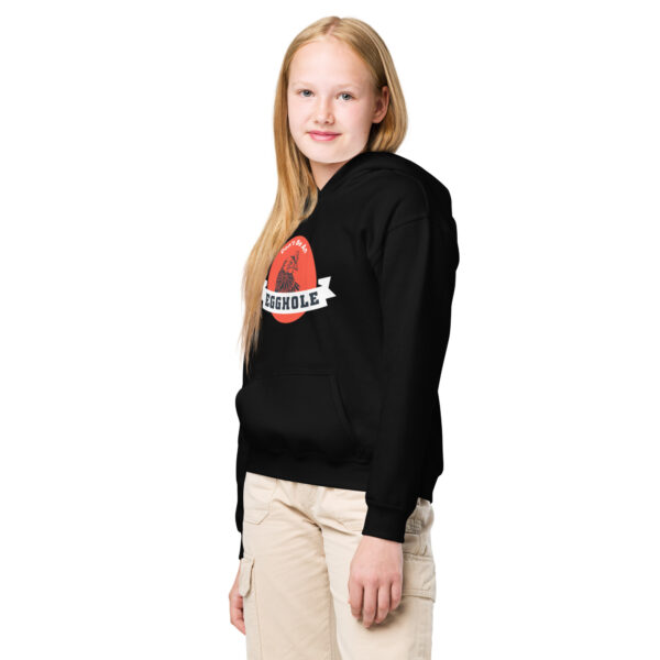 A girl wearing a black hoodie with the word " charlie " on it.