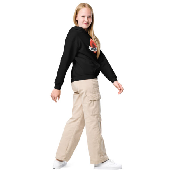 A girl in black shirt and beige pants.