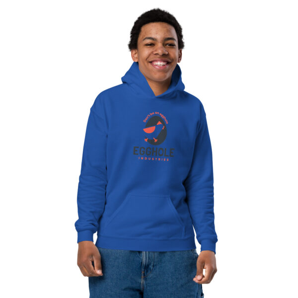 A young man wearing a blue hoodie with the word " s " on it.